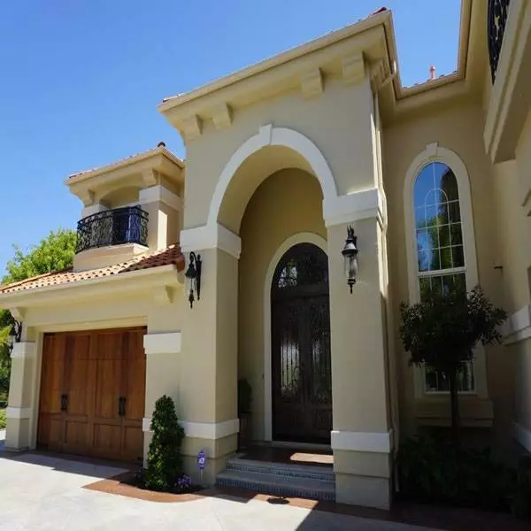 Exterior Of A Beautiful Mediterranean Style Home With Large Doors And Windows In North San Diego County Encinitas, Ca